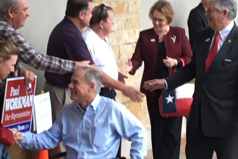 Gov. Greg Abbott greets supporters after voting early at a Randall's supermarket in far...