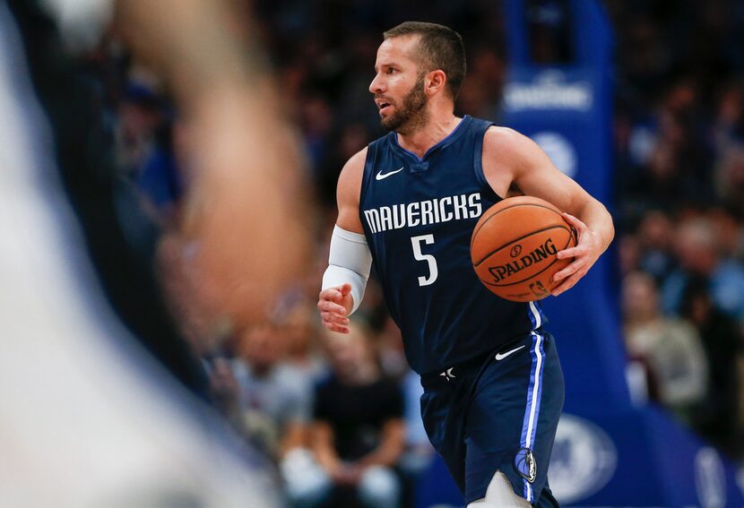 Dallas Mavericks guard J.J. Barea (5) brings the ball down during the second quarter of an...