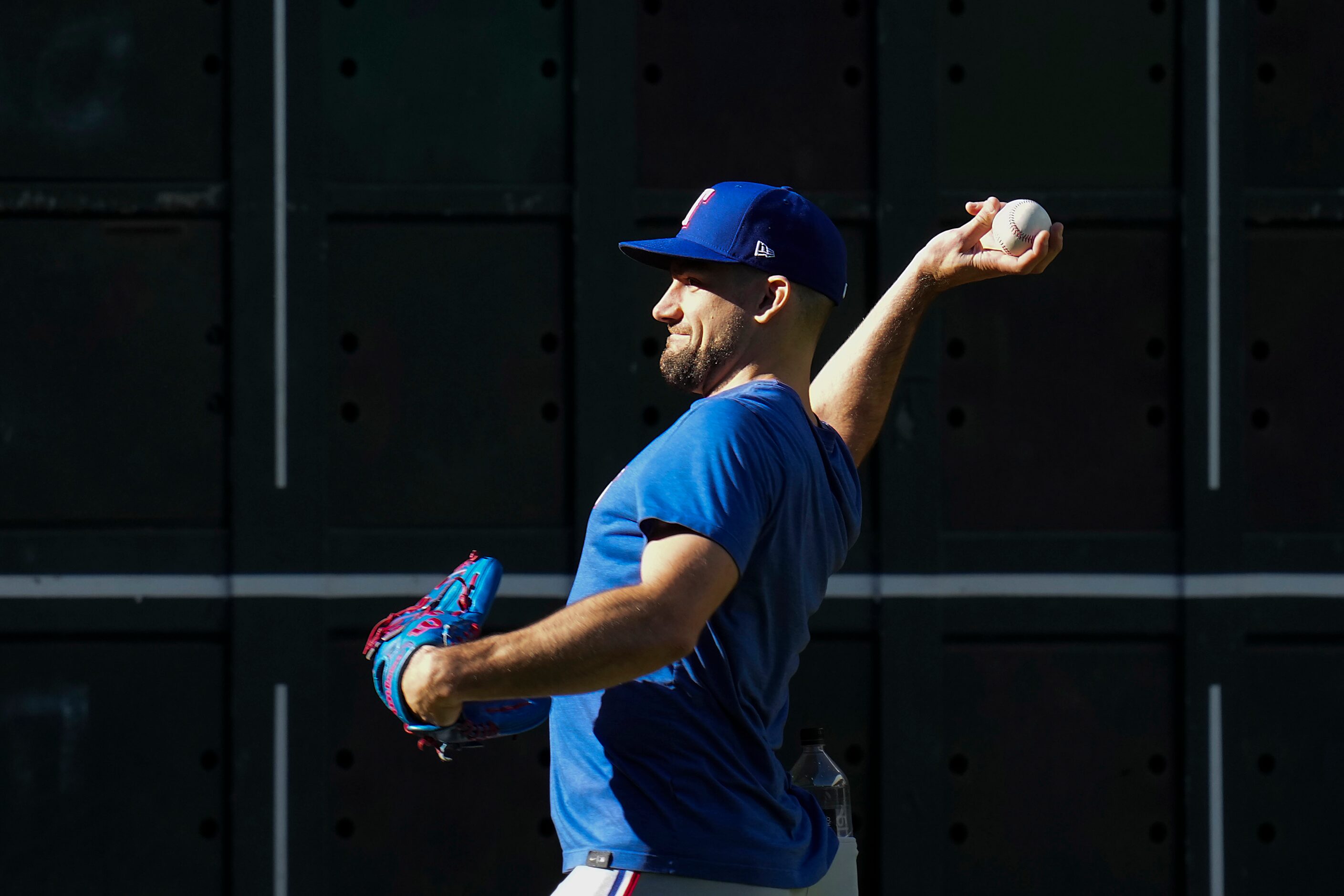 Texas Rangers starting pitcher Nathan Eovaldi throws in the outfield during a workout in...