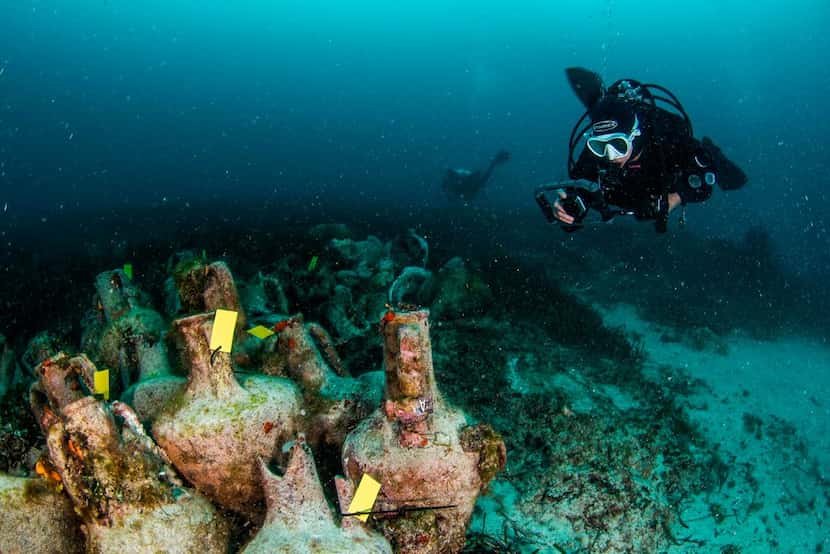 Divers explore the ruins of the ancient Greek shipwreck near the Aegean island of Alonissos,...