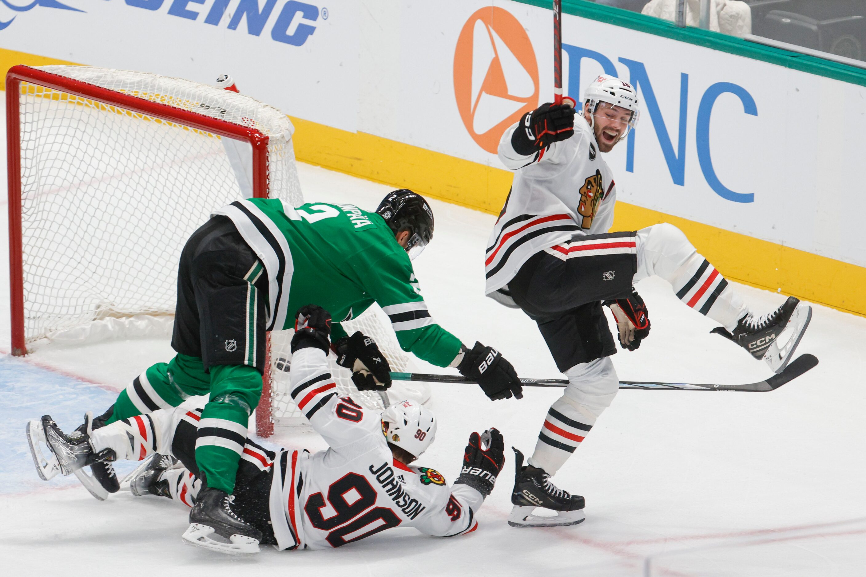 Chicago Blackhawks center Jason Dickinson (right) celebrates a goal scored by Chicago...