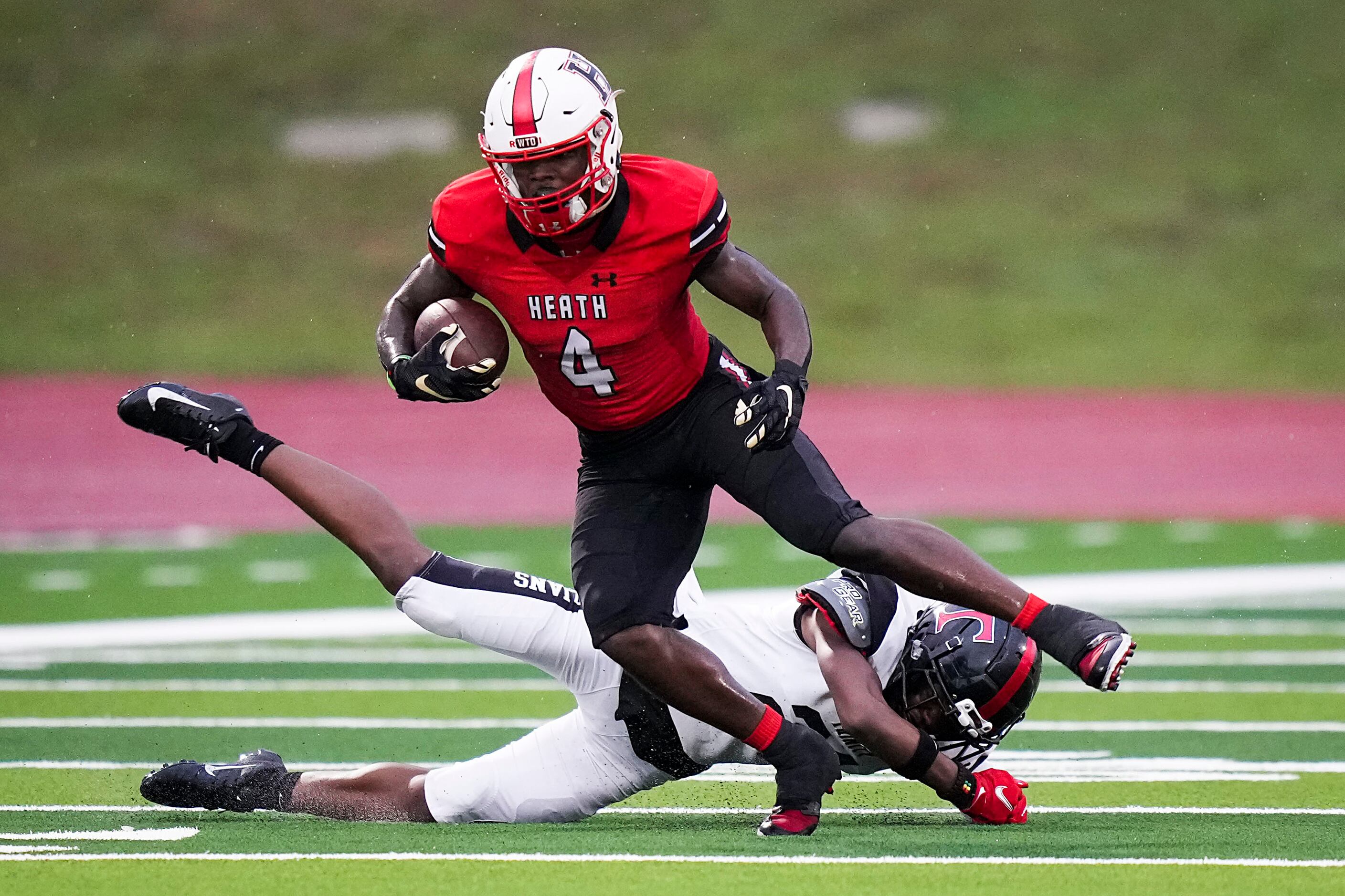 Rockwall-Heath wide receiver Burnts Lewis (4) breaks away from Euless Trinity defensive back...