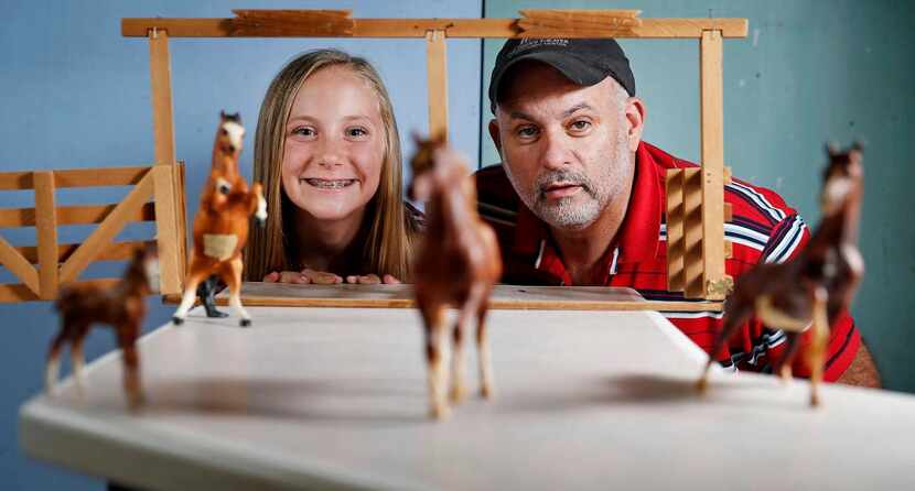 
McGeehon and his niece, Sadie, pose next to a horse stable prop McGeehon built as a child....