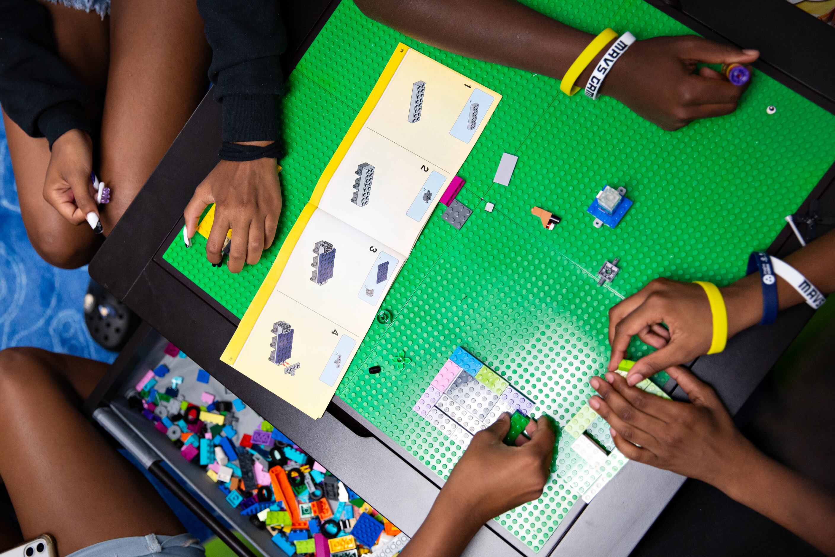 YMCA Teen Camp kids build lego structures at the Mavs Foundation’s unveiling of its newest...