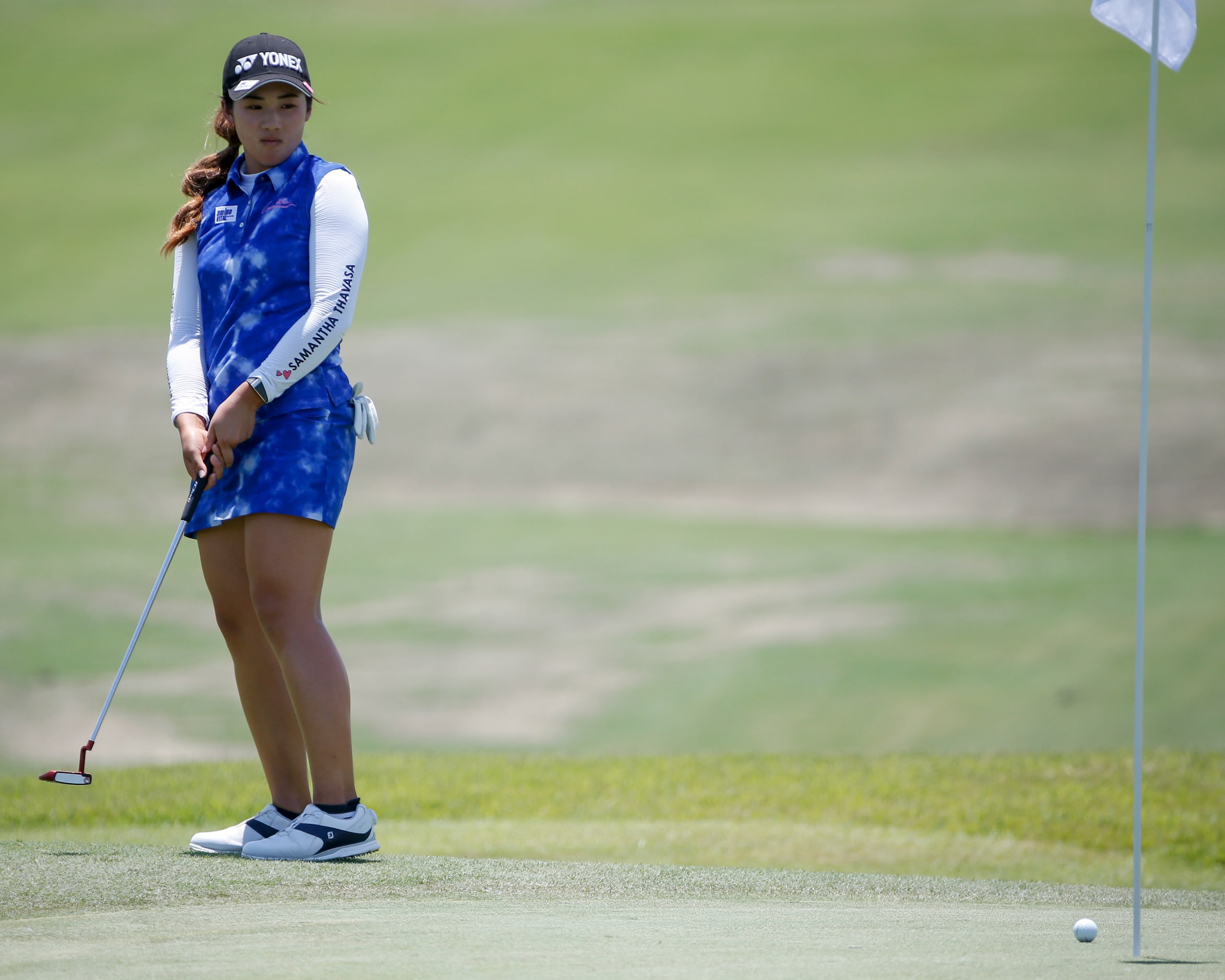 Professional golfer Suzuka Yamaguchi watches as her put stops short of the 17th hole during...