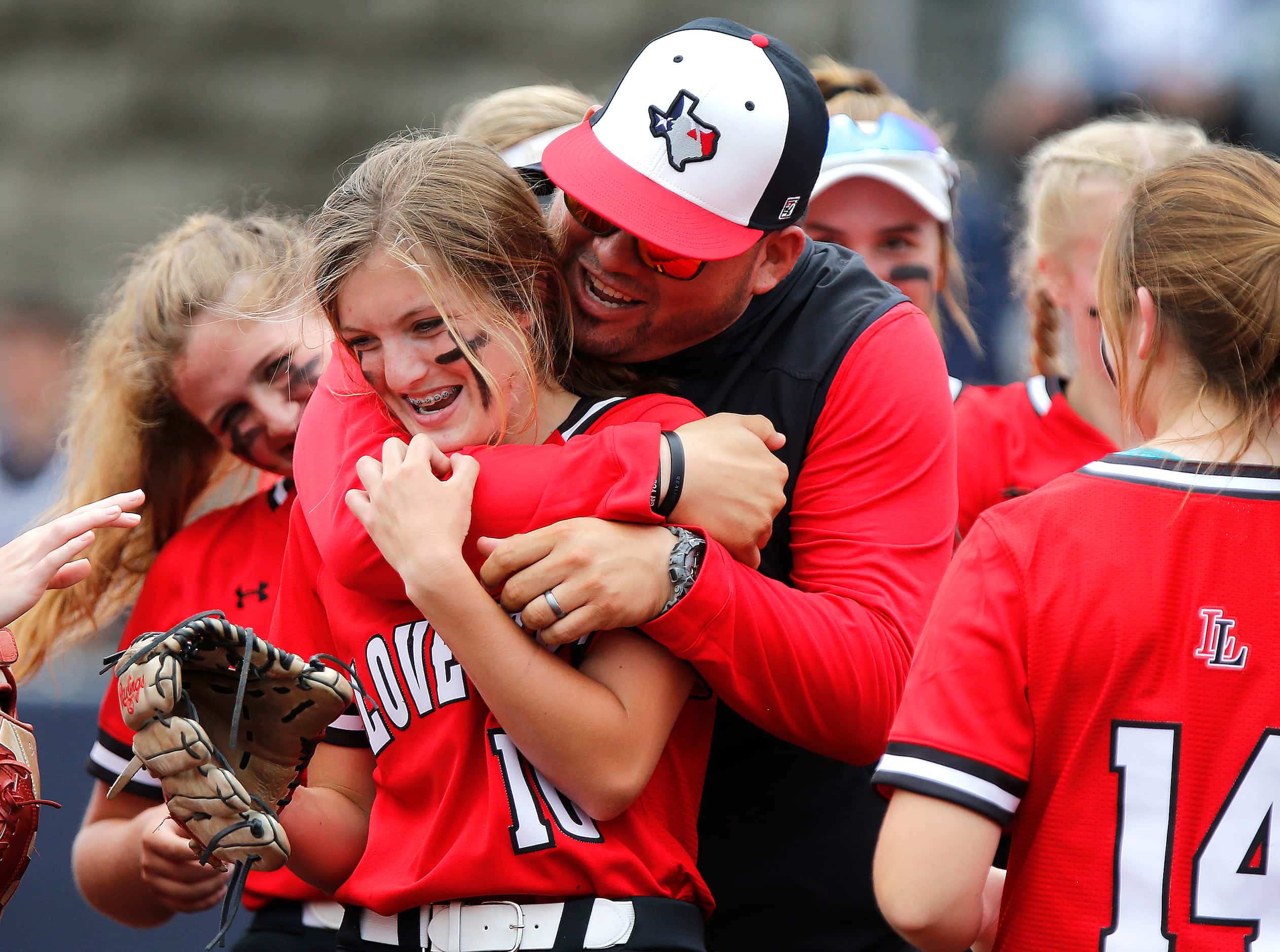 Lovejoy head coach Shawn Lewis embraces his left fielder Kamryn Messick (10) after she made...