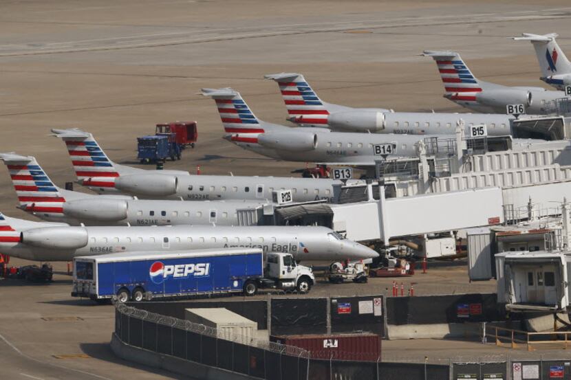 A line of American Eagle airplanes at Terminal B at DFW International Airport in Irving...
