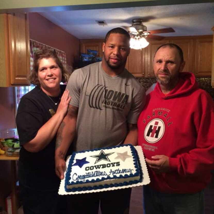 Anthony Hitchens celebrates with Amy and Brad Anderson after being selected in the fourth...