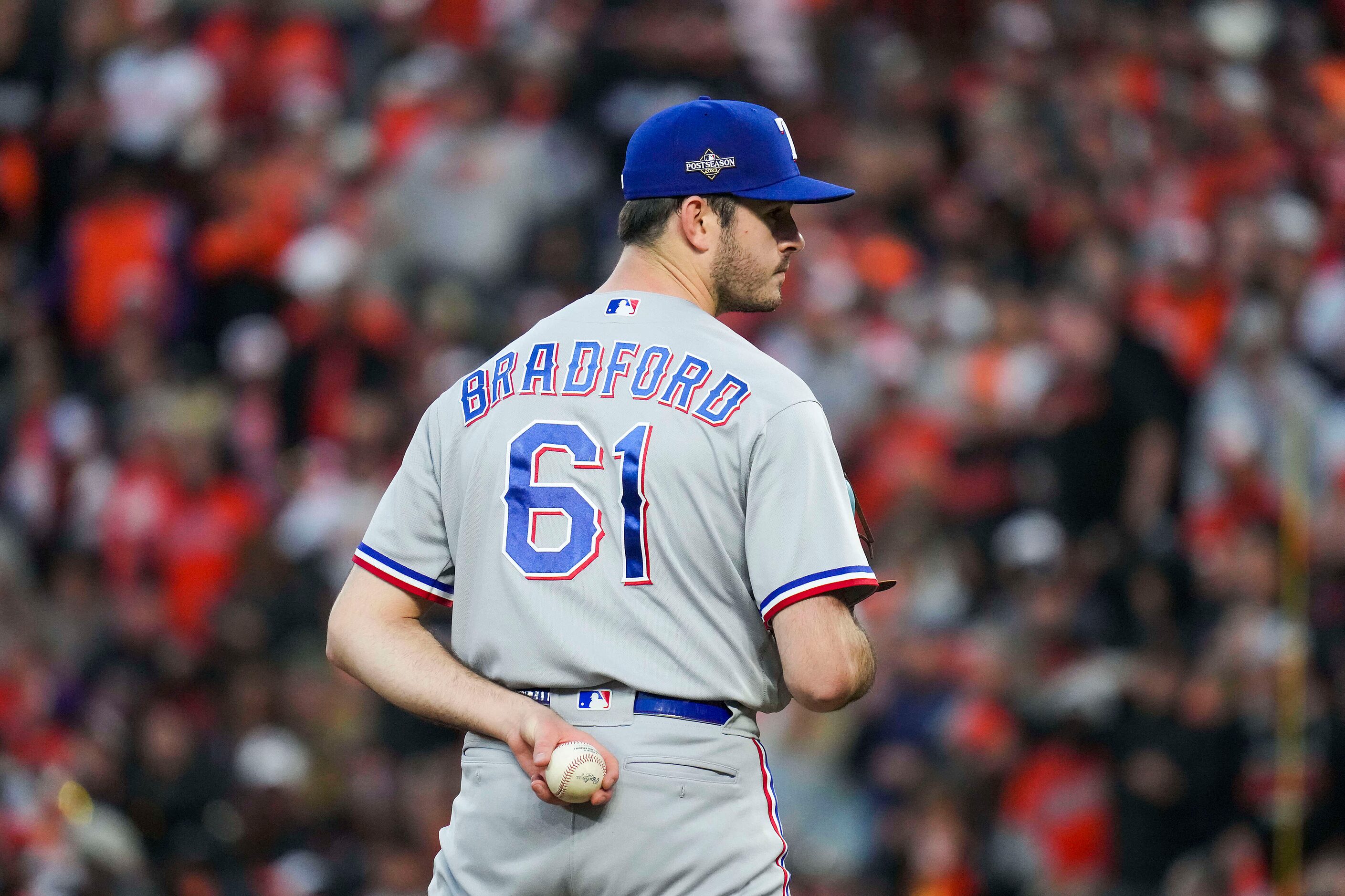 Texas Rangers pitcher Cody Bradford looks for a sign after entering the game during the...