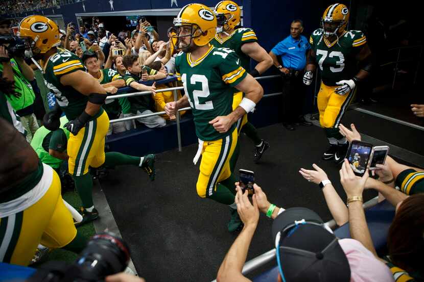 Green Bay Packers quarterback Aaron Rodgers (12) takes the field before an NFL football game...