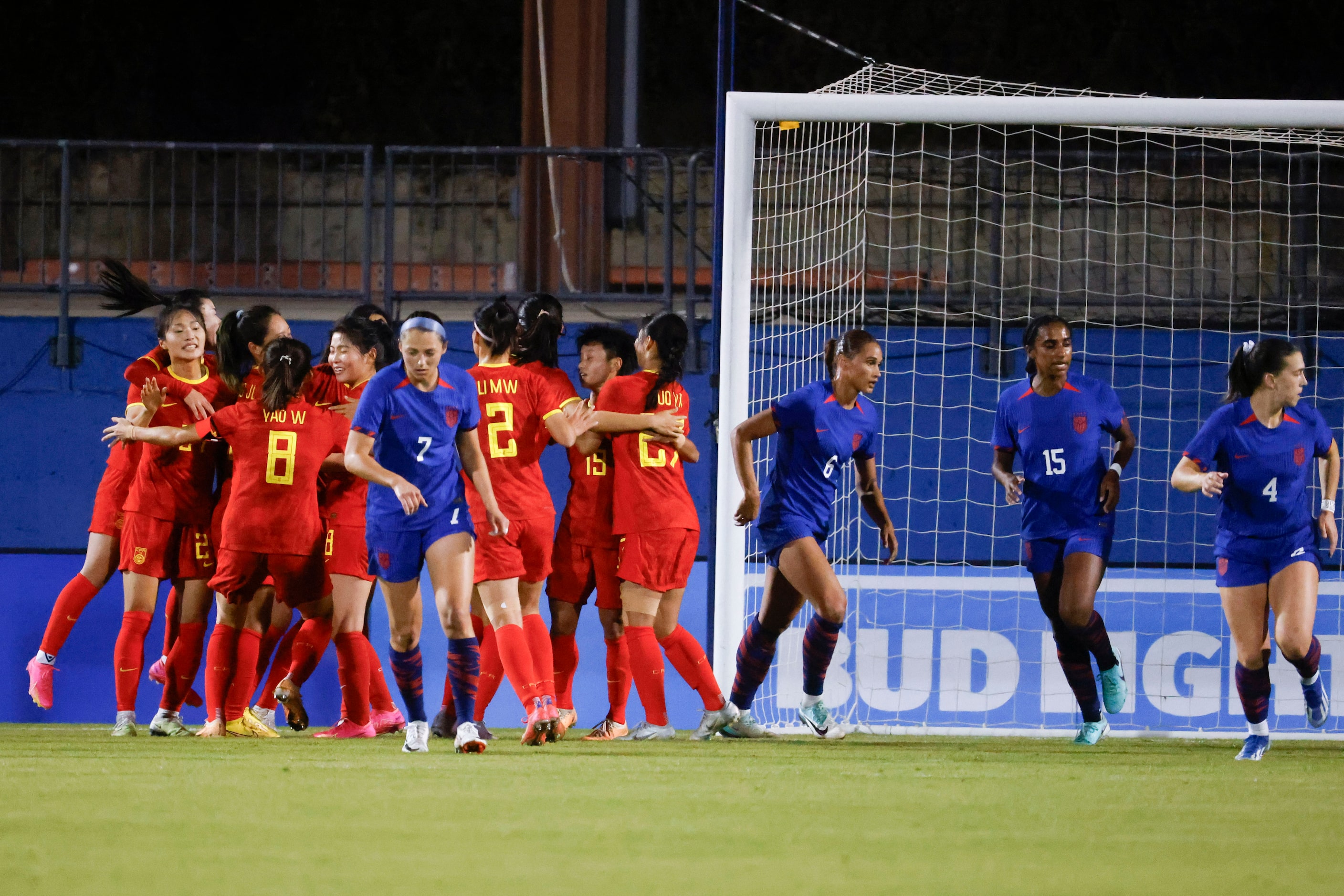 China players celebrate their only goal during the first half of a soccer game against...