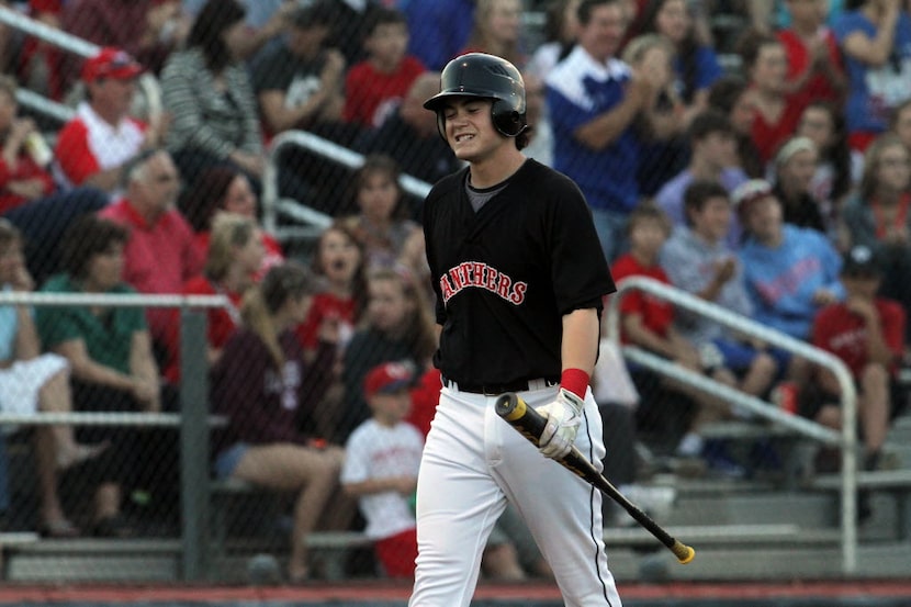 Colleyville Heritage first baseman Preston Palmeiro (25) grimaces as he returns to the...