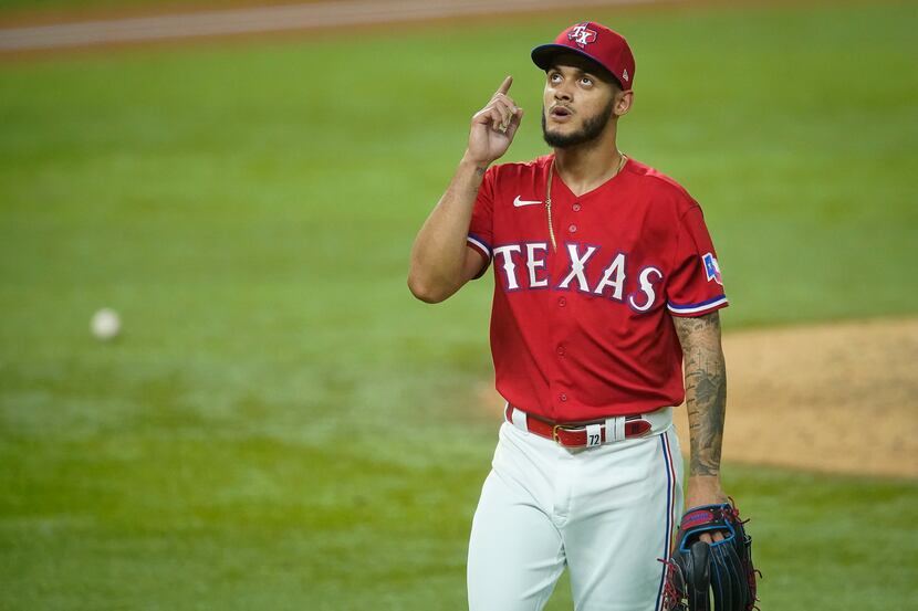 Texas Rangers pitcher Jonathan Hernandez heads for the dugout after giving up one run to the...