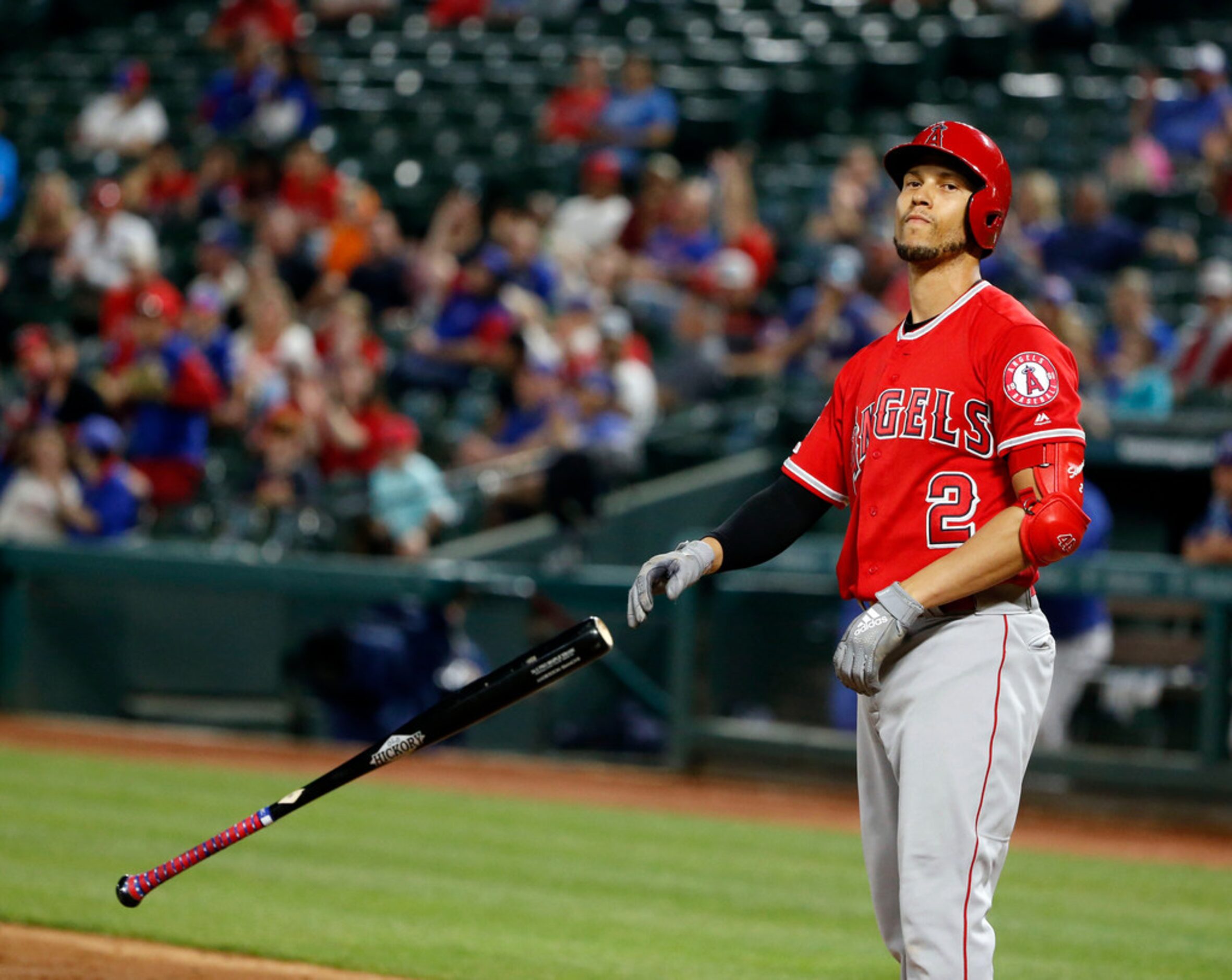 Los Angeles Angels' Andrelton Simmons tosses his bat after striking out against the Texas...