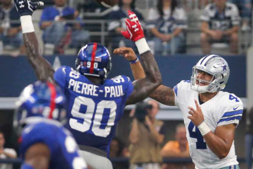 Dallas Cowboys quarterback Dak Prescott (4) throws a pass as New York Giants defensive end...