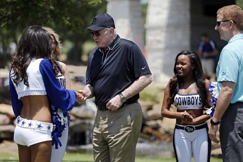 Dallas Cowboys owner Jerry Jones (center) talks cheerleaders during the team's annual...