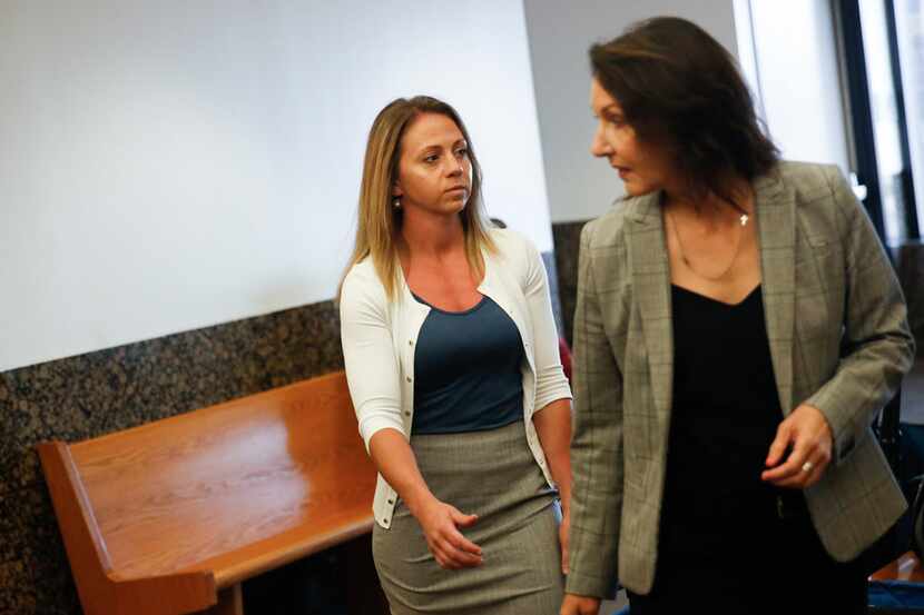 Former Dallas police Officer Amber Guyger (left) enters the 204th District Court in the...