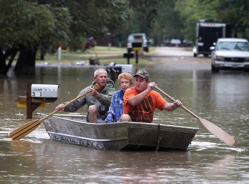 
J.B. Neckar (right) and his brother Johnny paddled their mother away from her flooded home...