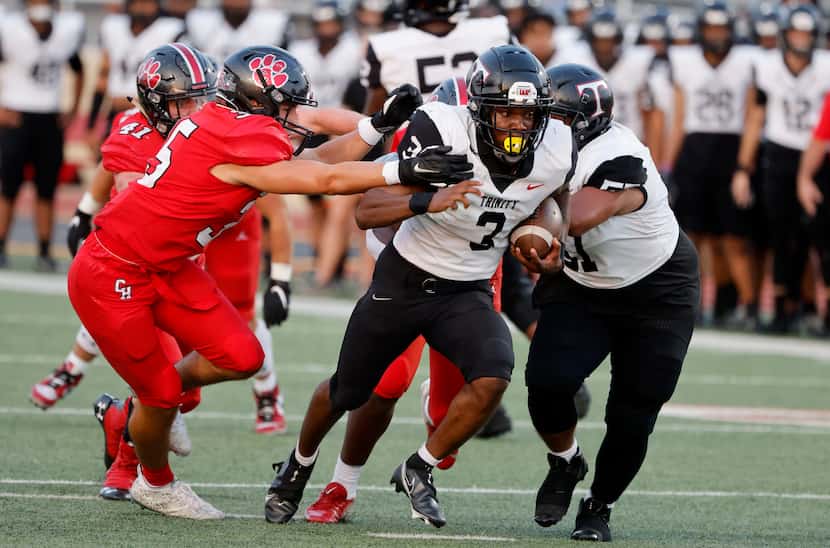 Colleyville’s Nathan Miller (left) fails to contain Euless Trinity’ running back Gary Maddox...