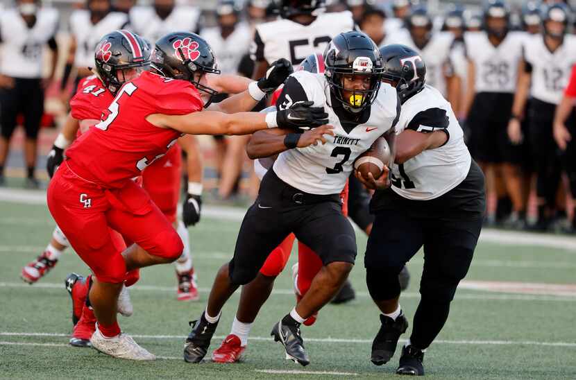 Colleyville’s Nathan Miller (left) fails to contain Euless Trinity’ running back Gary Maddox...