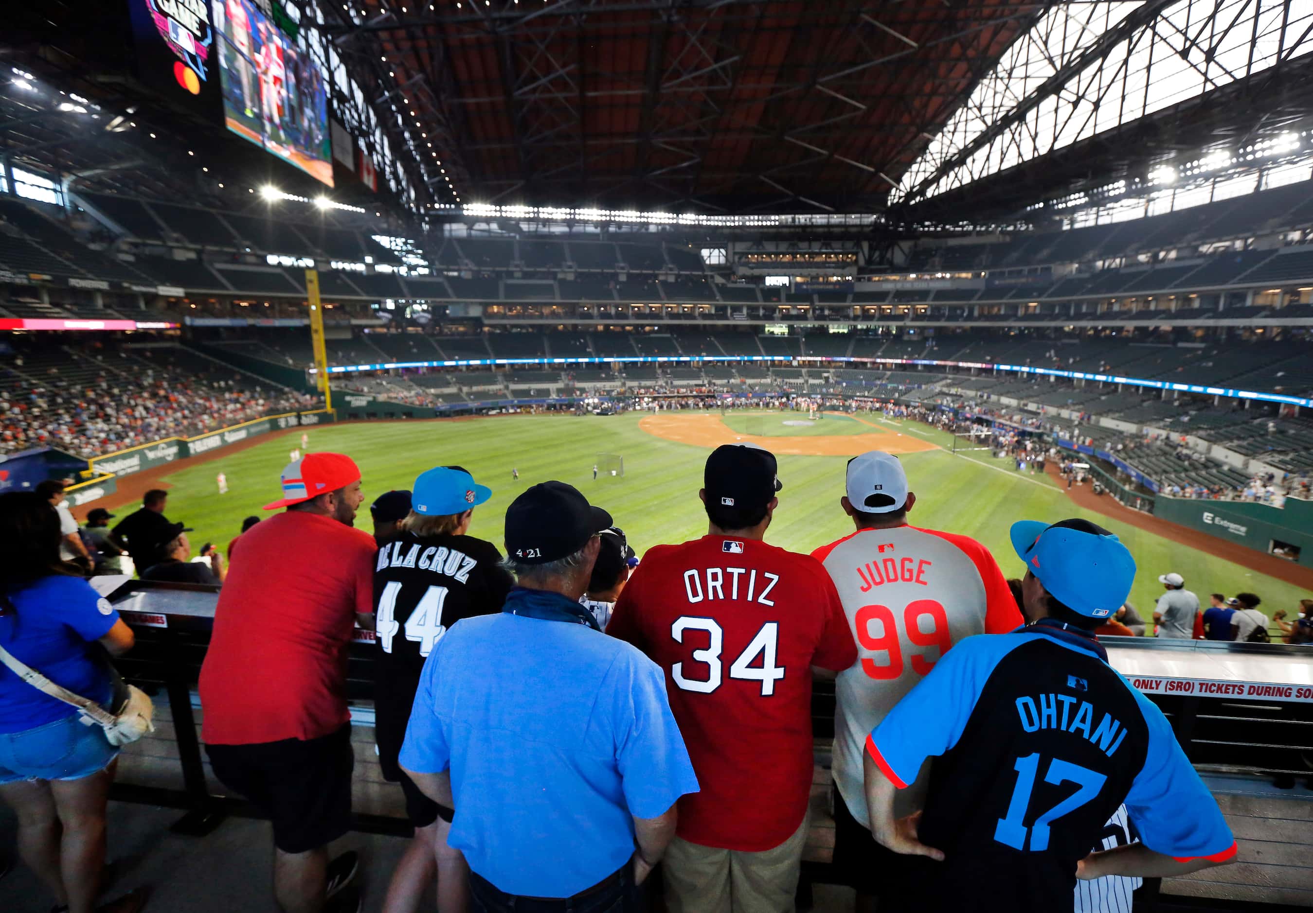 Baseball fans watch batting practice from the right field concourse before the MLB All-Star...