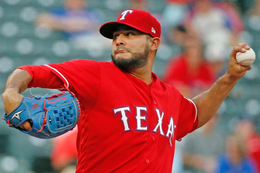 Texas Rangers starting pitcher Martin Perez (33) throws a forst-inning pitch during the...