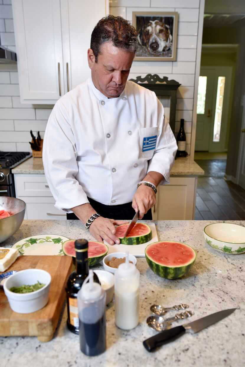 John Lymberopoulos, executive chef for the Greek Food Festival, slices a watermelon as he...