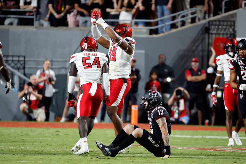 Texas Tech's Tyree Wilson celebrates a sack with teammate Bryce Ramirez (54) during the...