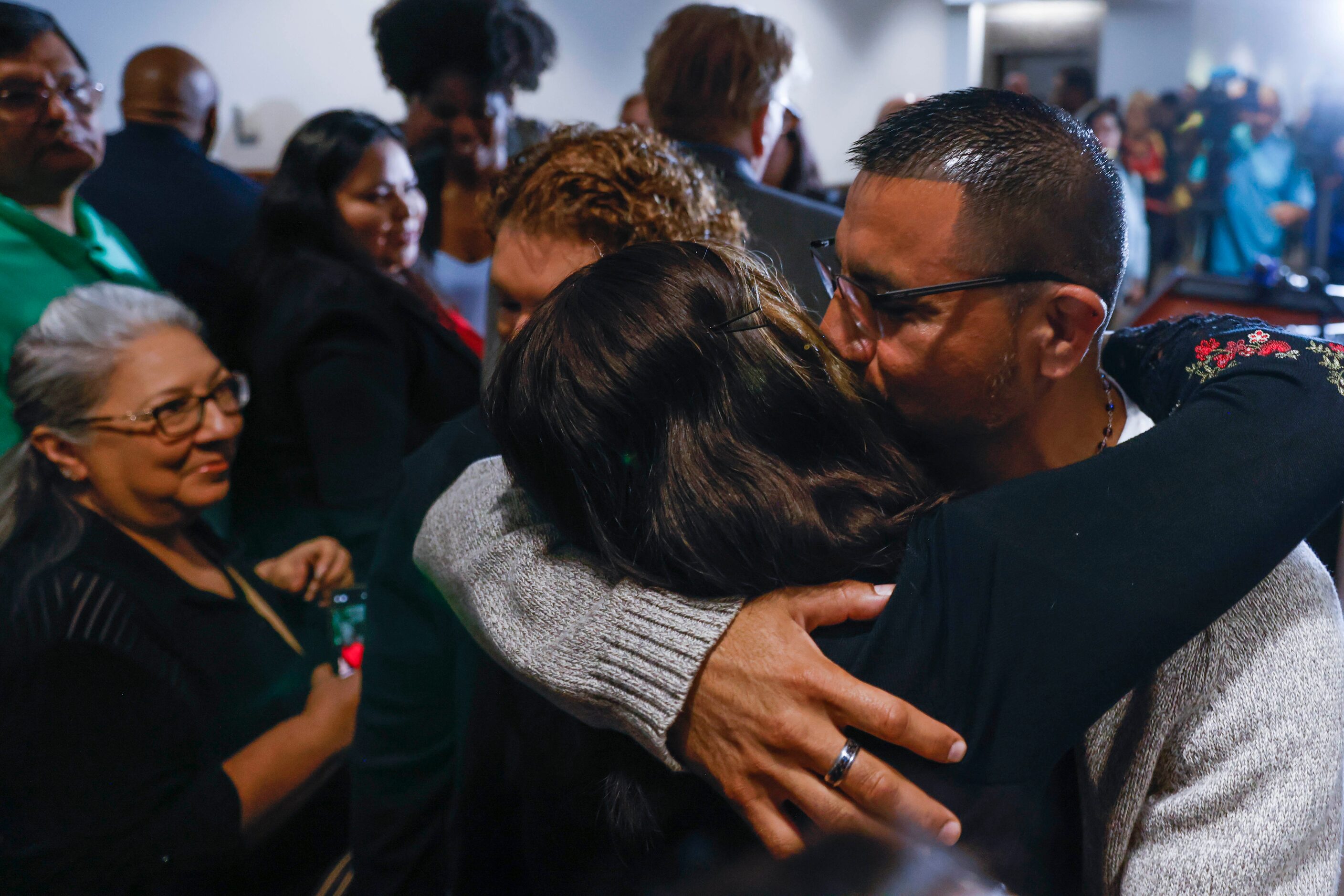 Martin Santillan kisses his sister Chayra De La Rosa (left) ahead of a press conference...