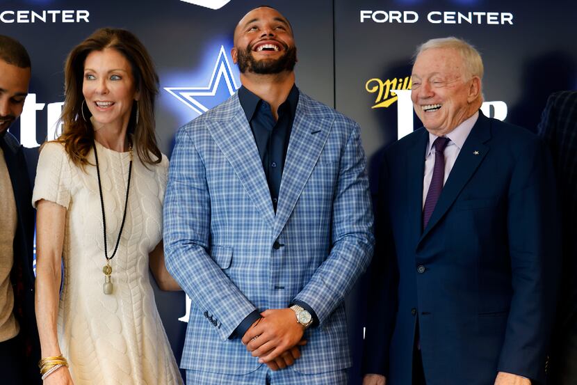 Dallas Cowboys quarterback Dak Prescott (center) laughs with owner Jerry Jones and Executive...