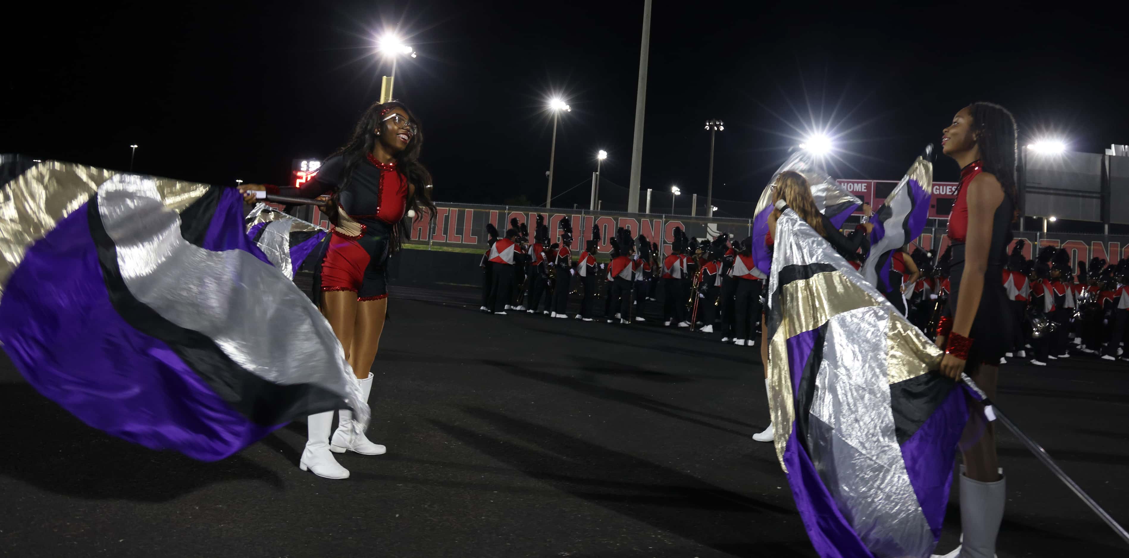 Members of the Cedar Hill color guard squad warm up prior to their 
on-field performance...