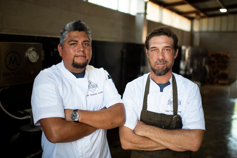 Damian Avila (left) and Tim McLaughlin stand in the smoke room at Crossbuck BBQ in Farmers...