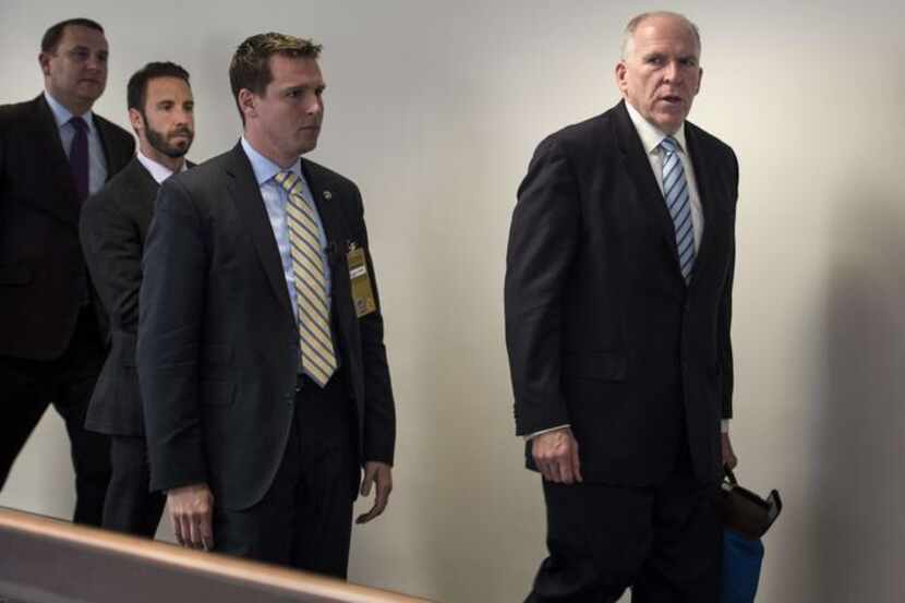 
CIA Director John Brennan (right) leaves a closed briefing of the Senate Intelligence...