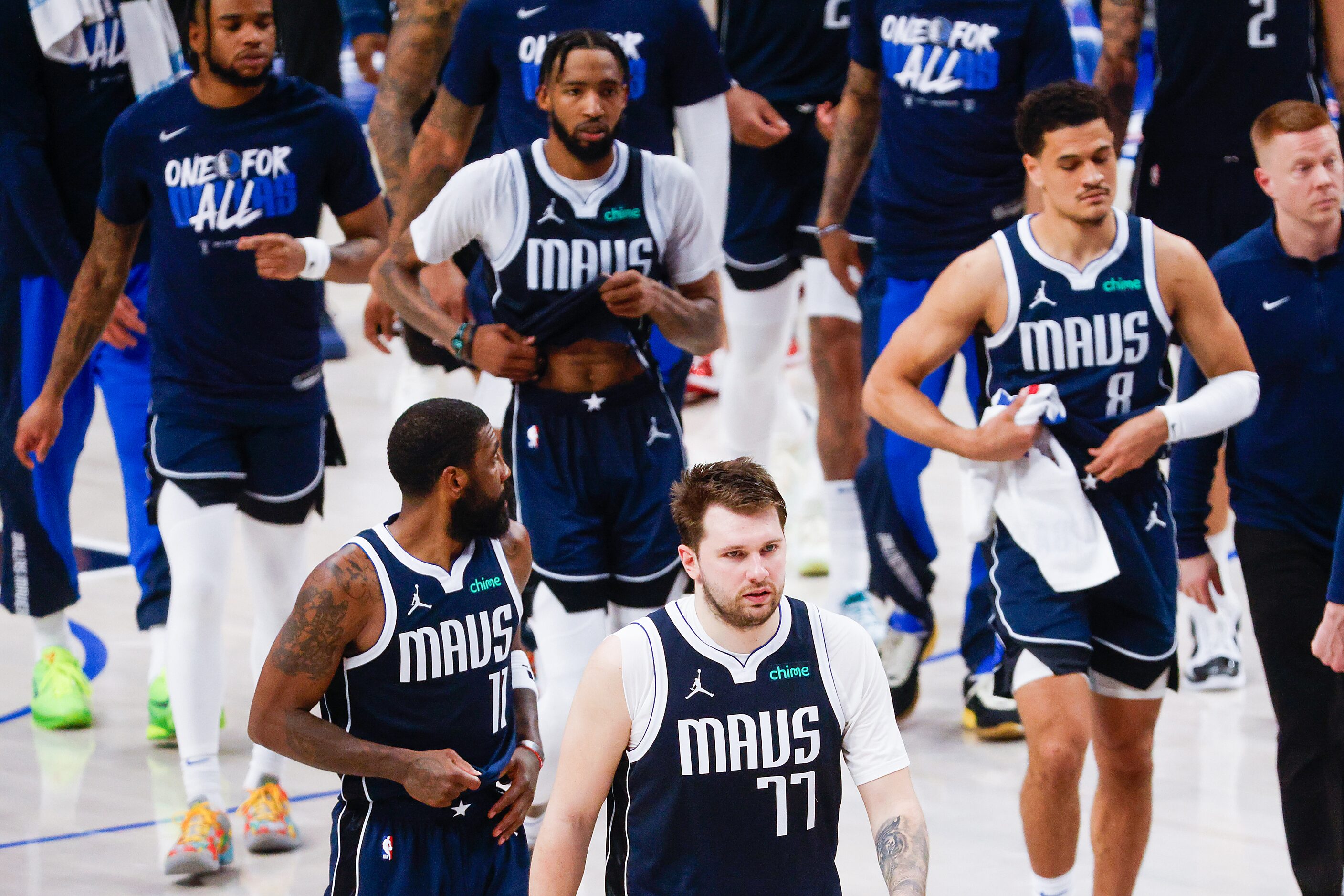 Dallas Mavericks guard Luka Doncic (77)  leave the court with teammates after a loss to the...