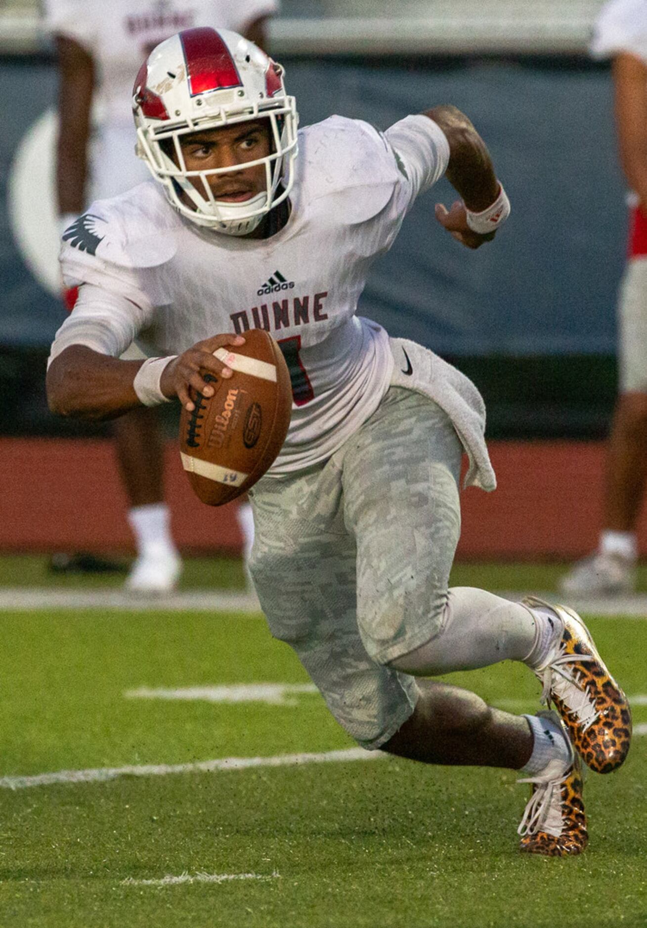 Bishop Dunne quarterback Simeon Evans (1) makes a run for yards during a game against All...