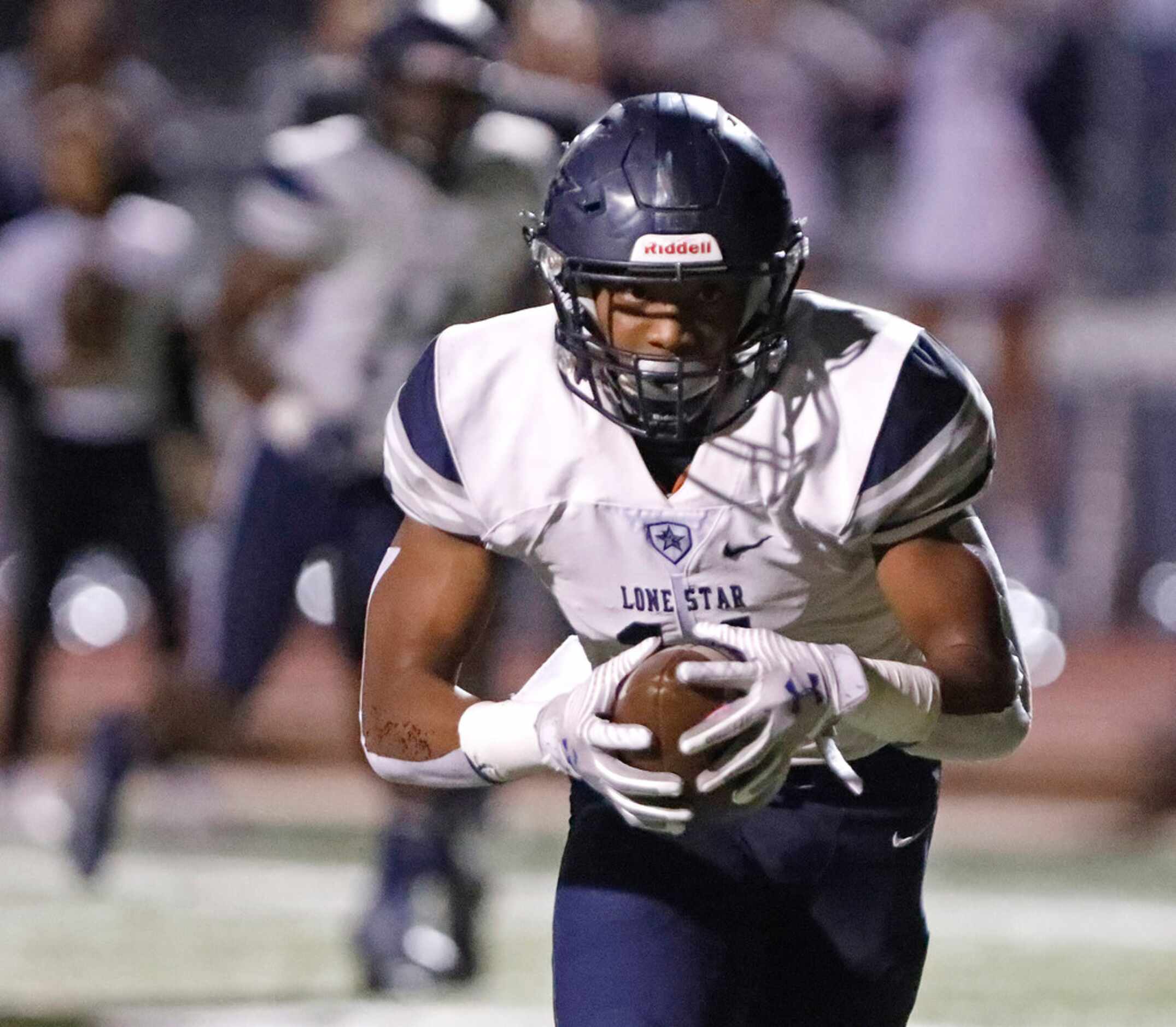 Lone Star High School wide receiver Brandon Spencer (11) runs after the catch during the...