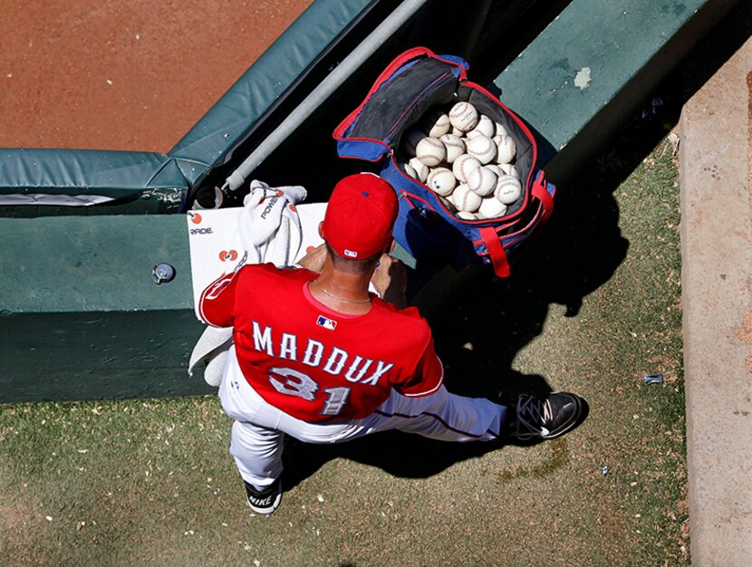  Texas pitching coach Mike Maddux prepares for the game in the bullpen before the New York...