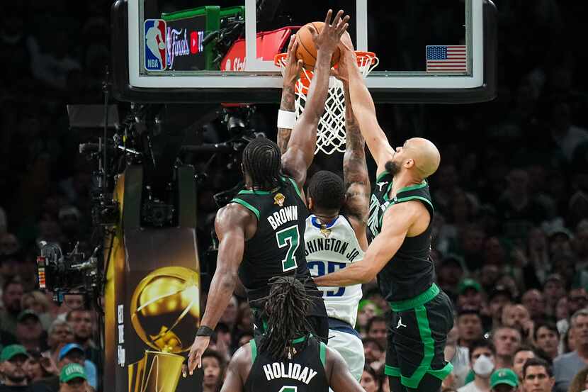 Boston Celtics guard Derrick White (9) blocks a dunk attempt by Dallas Mavericks forward...