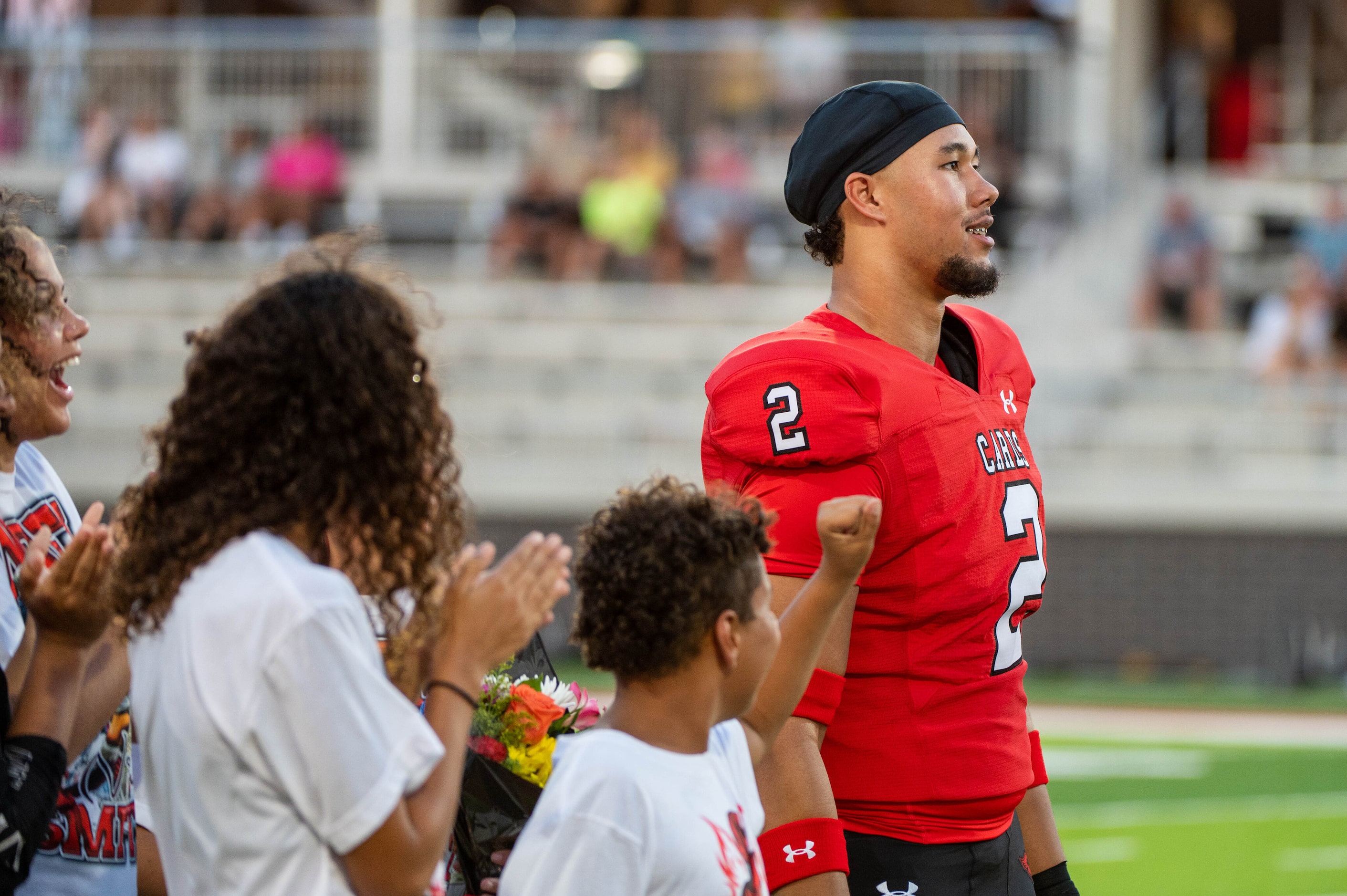 Melissa defensive end Nigel Smith (2) reacts with his family after he made his college...