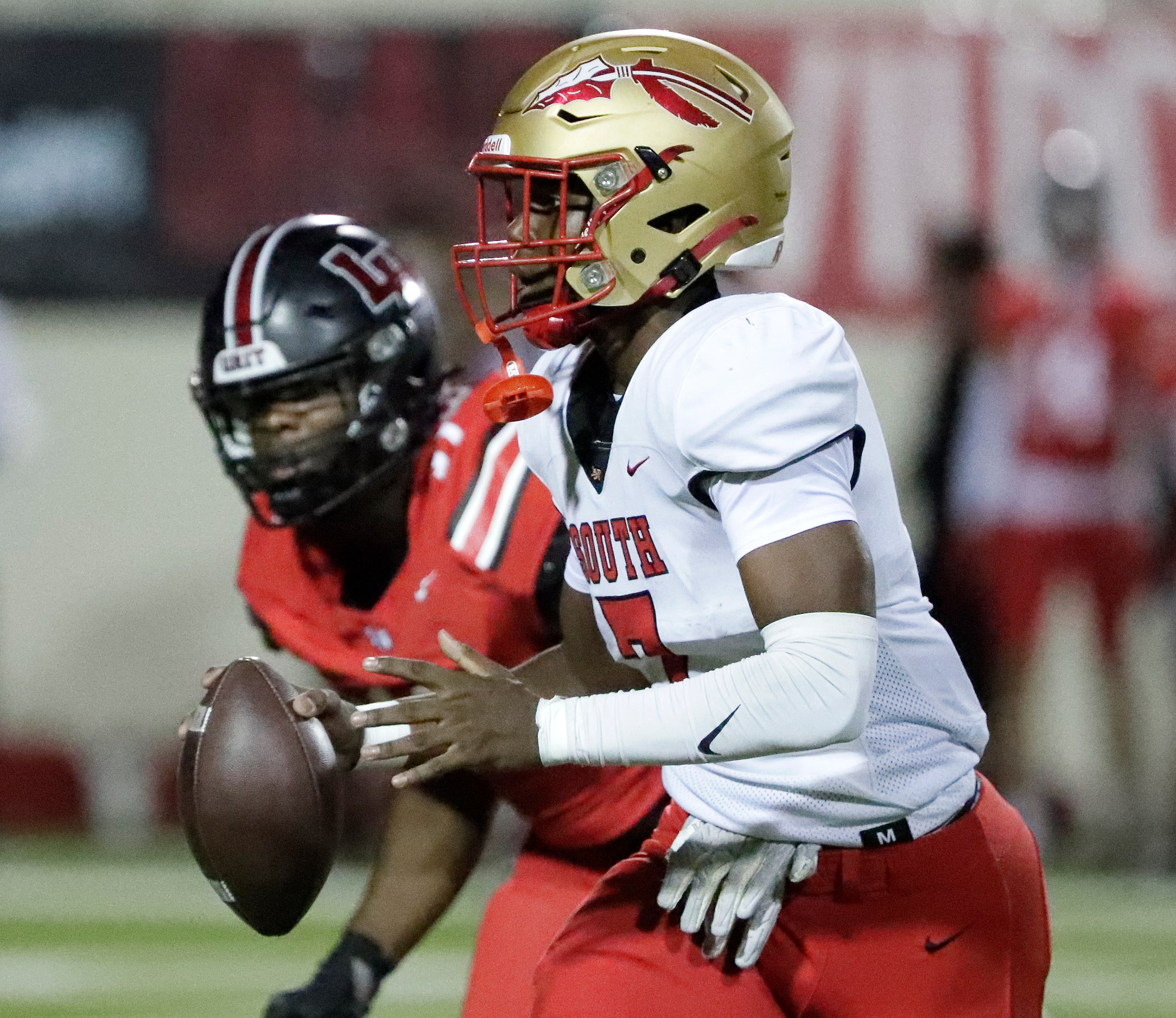 South Grand Prairie High School quarterback Ryan Goss (7) rolls out under pressure during...