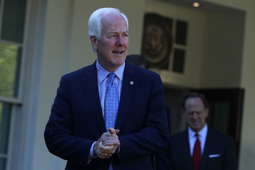 Senate Majority Whip Sen. John Cornyn comes out from the West Wing of the White House after...