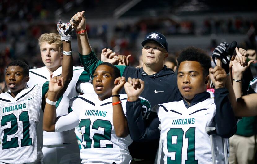 Waxahachie head coach Jon Kitna joins his players in the alma mater following their loss to...