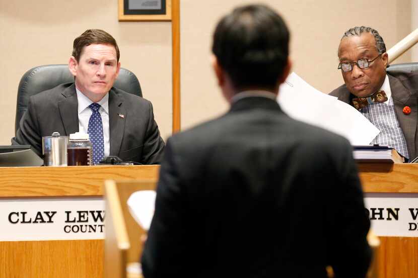 Dallas County Judge Clay Jenkins (left) and Commissioner John Wiley Price (right) listen to...