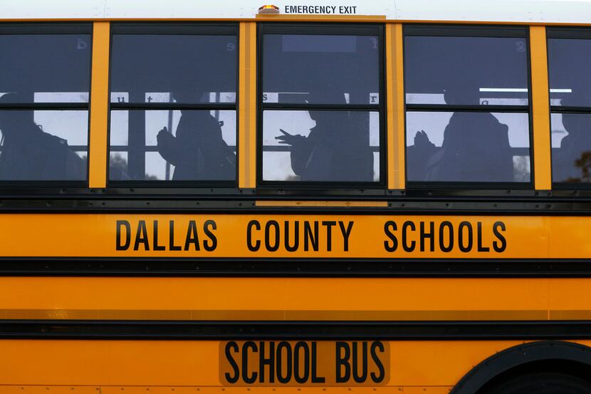 Buses drop students off at W.E. Greiner Exploratory Arts Academy in Dallas on Oct. 25, 2017.