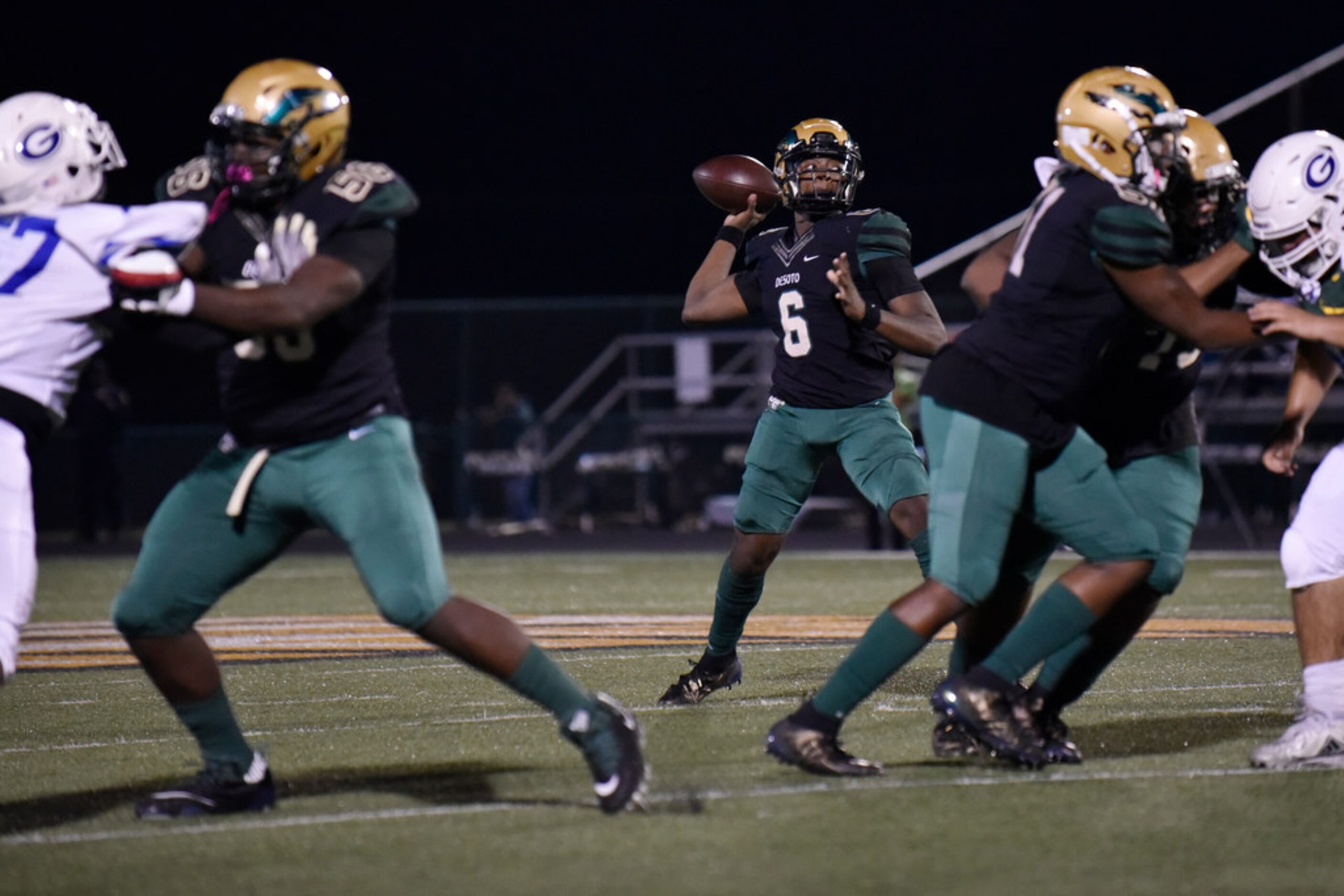 DeSoto High School junior quarterback Samari Collier (6) prepares to throw a pass as he's...