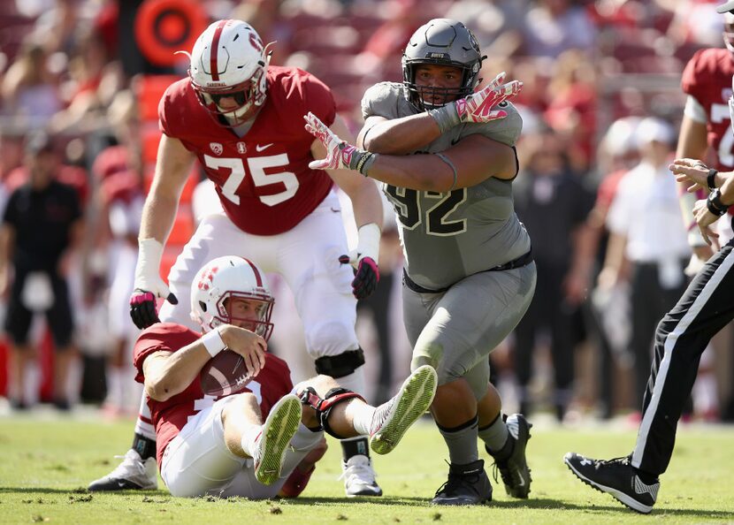 Jordan Carrell #92 of the Colorado Buffaloes reacts after he sacked Ryan Burns #17 of the...