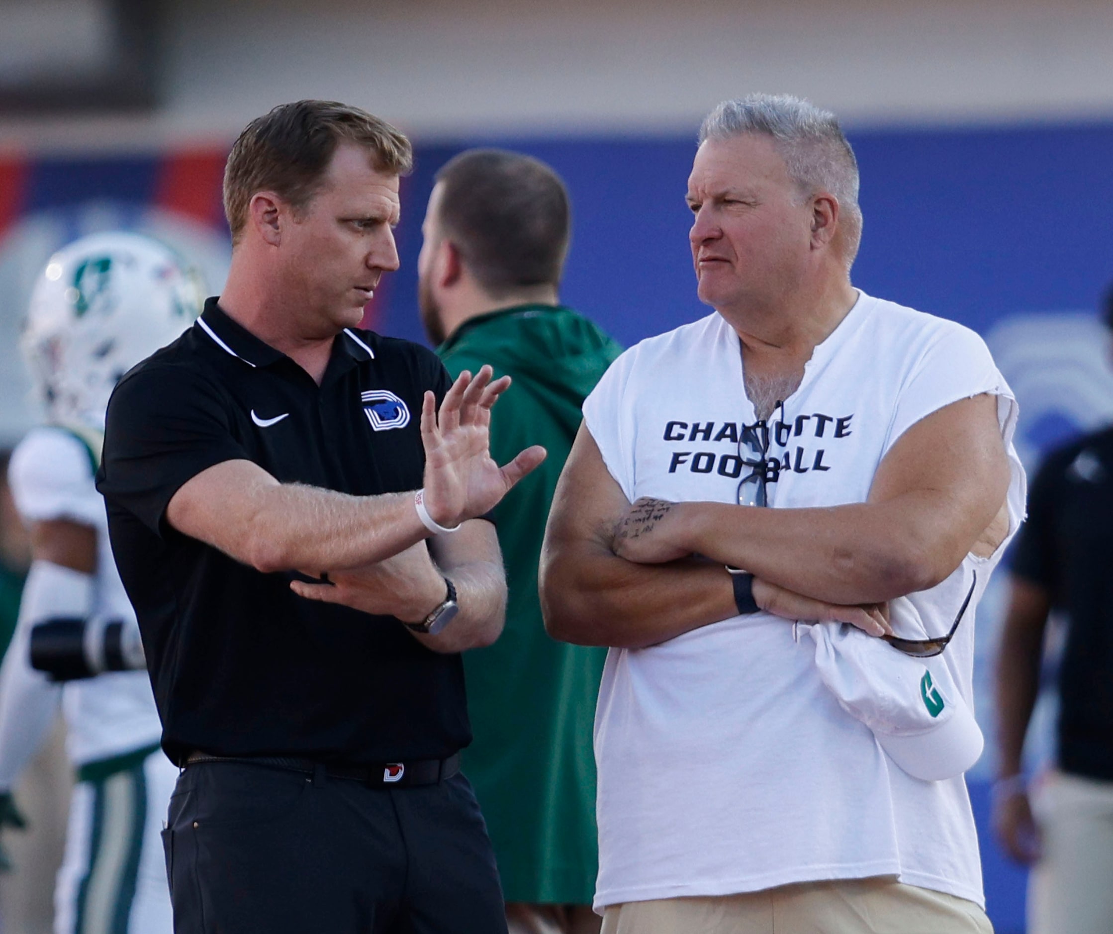 SMU head coach Rhett Lashlee, left, speaks to Charlotte 49ers head coach Biff Poggi before...