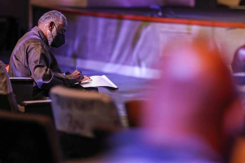 Robert Smith, seminary teacher at Beeson Divinity School, takes notes during a panel...