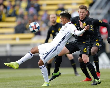 FC Dallas forward Jesus Ferreira (27) kicks the ball over Columbus Crew midfielder Wil Trapp...