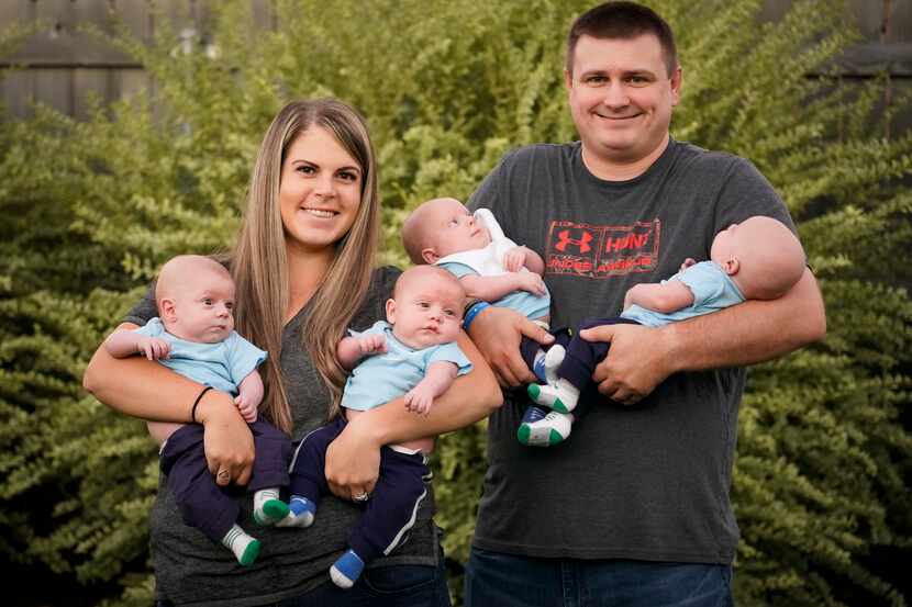 Katie and Chris Sturm with their quadruplets, from left, Daniel, Austin, Hudson and Jacob,...
